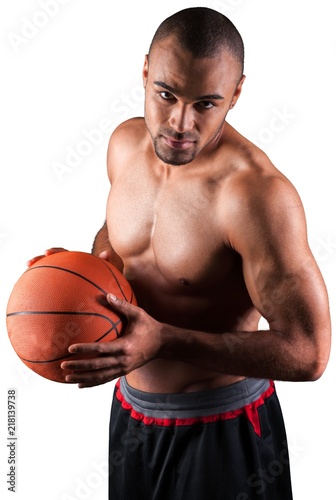 Portrait of young handsome sporty man with ball isolated on