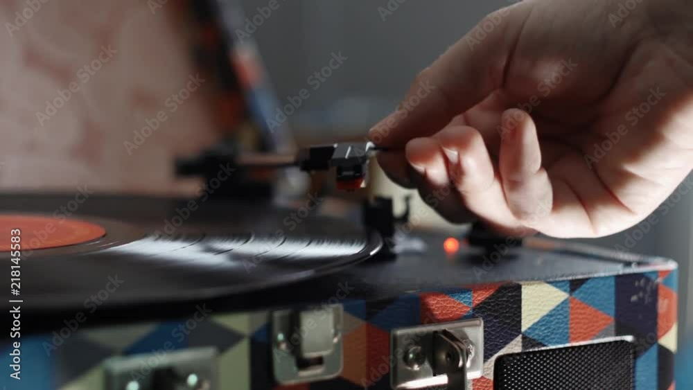 Putting a record on. Close of needle dropping and record starting up. Putting a record on. Close of needle dropping and record starting up.