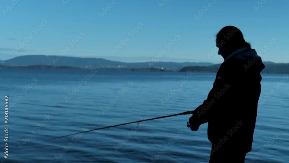 Female fishing in the morning before sunset in Oslo, Norway. Female fishing in the morning before sunset in Oslo, Norway.