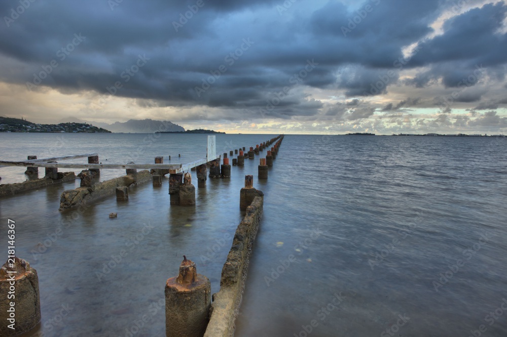 HDR old dock wreckage with ocean and clouds HDR old dock wreckage with ocean and clouds
