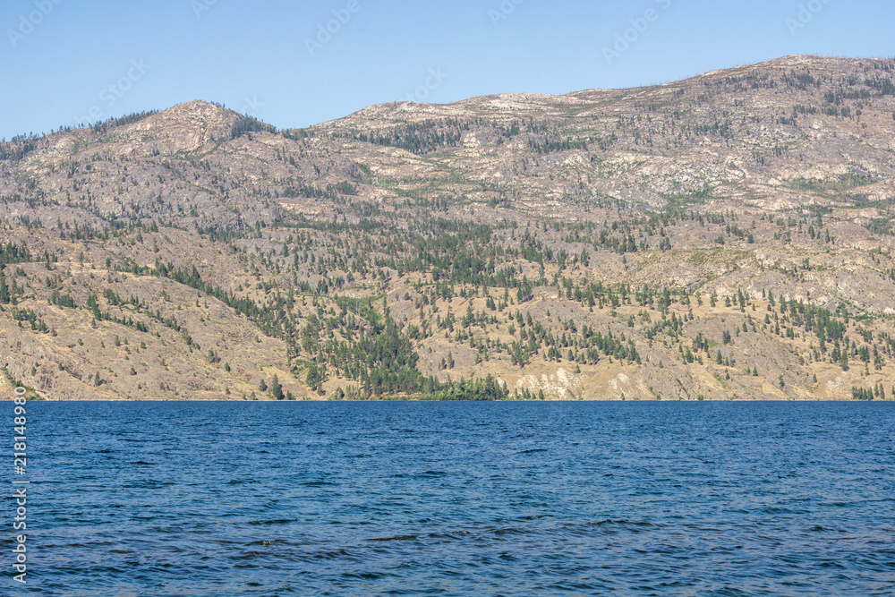 Okanagan lake at summer day with blue sky.