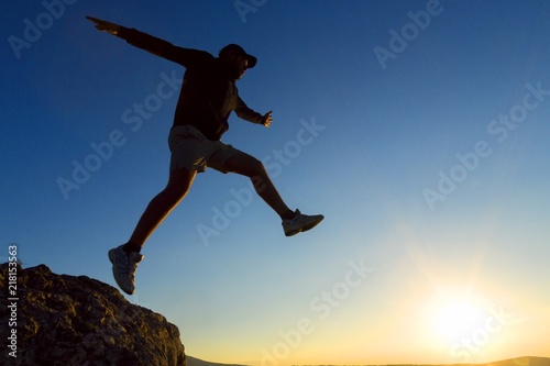 Man Jumping on Rocks