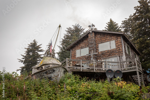 Remote House with Fishing Boat in Front in Alaska photo