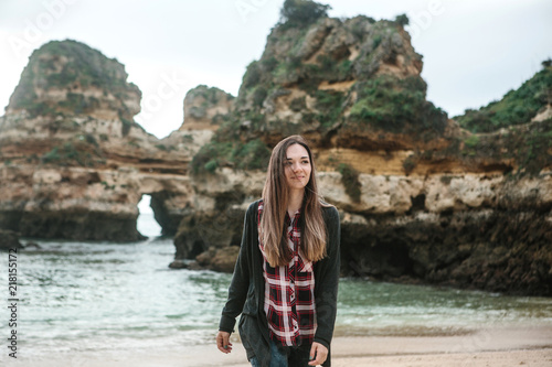 Portrait of a young beautiful girl walking along the Atlantic coast in Portugal and enjoying life.