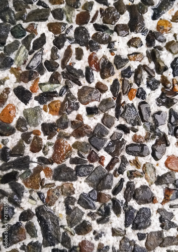 Background pattern with texture of gray, brown and black rocks or stones with wet effect