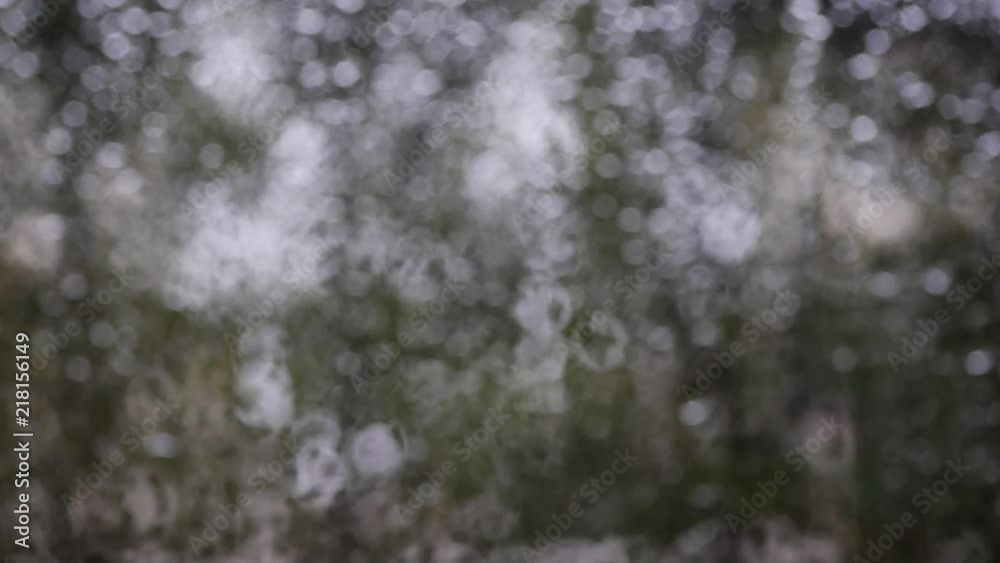 blur bokeh evening scene of rain drops on glass window blur bokeh evening scene of rain drops on glass window