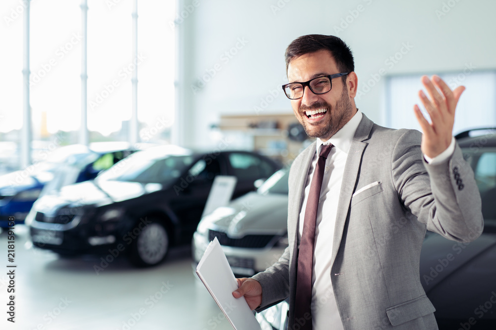 Salesperson at car dealership selling vehicles Salesperson at car dealership selling vehicles