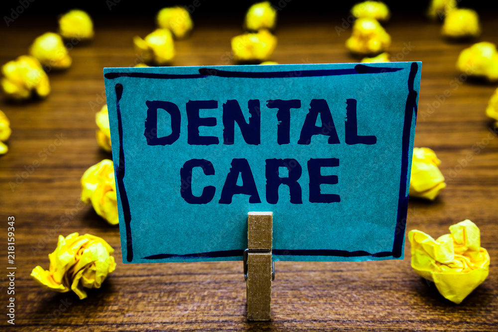 Naklejka premium Word writing text Dental Care. Business concept for maintenance of healthy teeth or to keep it clean for future Clothespin holding blue paper note crumpled papers several tries mistakes.