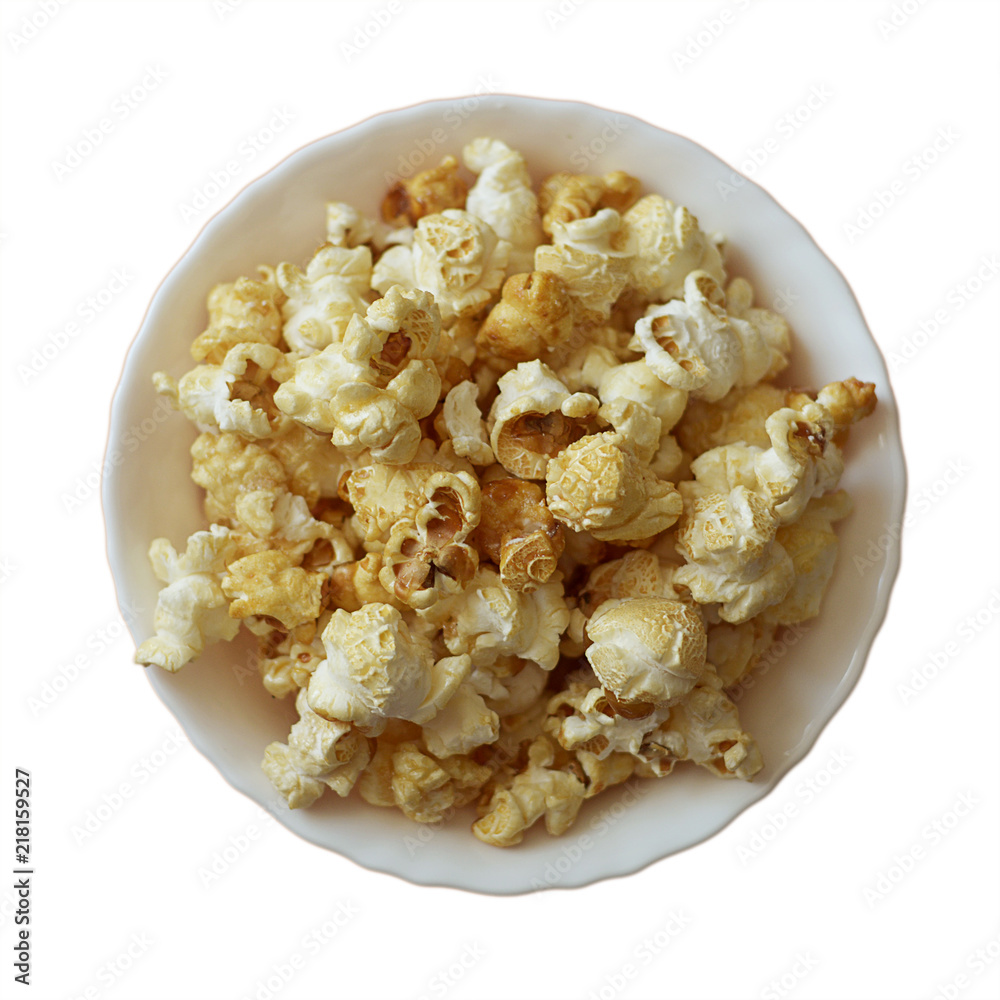 Popcorn in a white ceramic bowl on a white background. Top view, square. Isolate. Popcorn in a white ceramic bowl on a white background. Top view, square. Isolate.