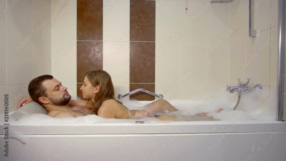 Couple in love having fun during romantic bath