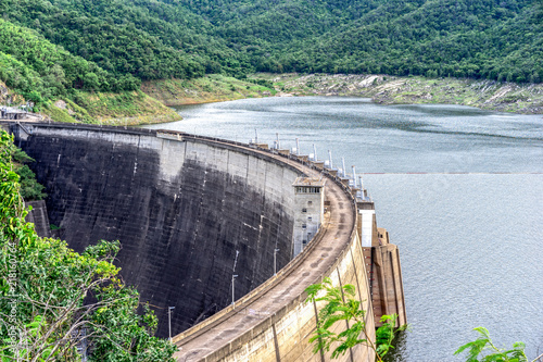 Large concrete dam. Reservoirs created by dams suppress floods, activities such as irrigation and human consumption. Hydropower is often used in conjunction with dams to generate electricity.