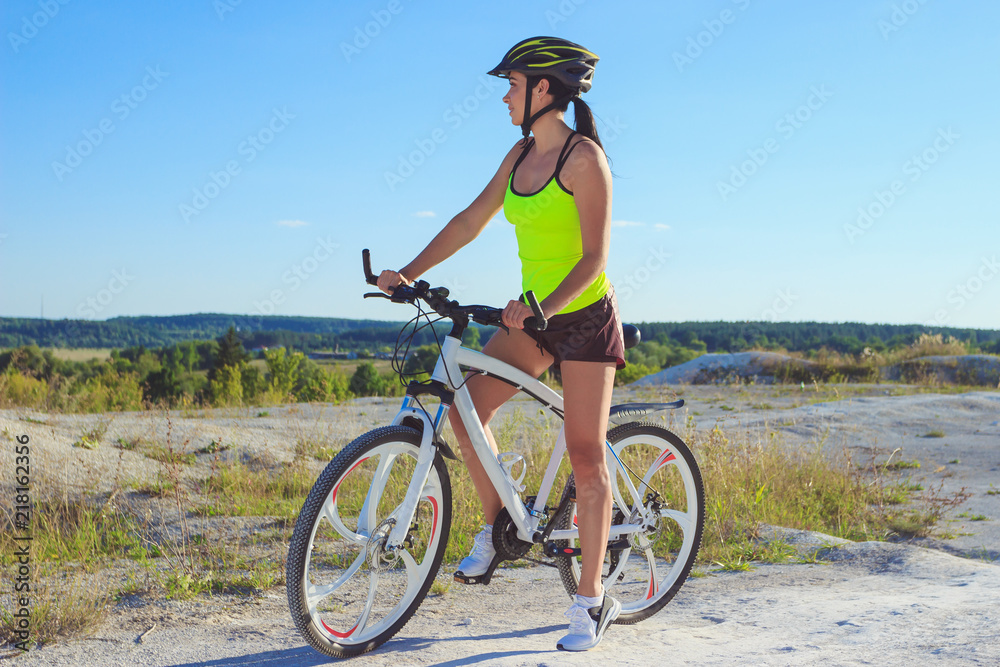 Woman on a bicycle against the blue sky Woman on a bicycle against the blue sky