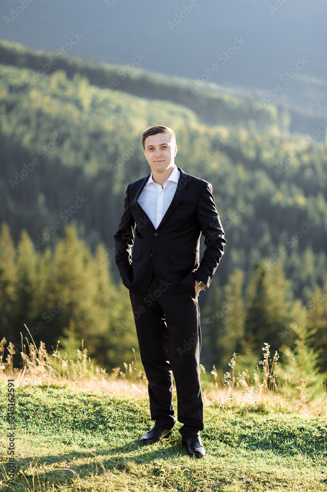Portrait of a handsome groom posing outdoors on his wedding day. Portrait of a handsome groom posing outdoors on his wedding day.