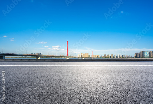 empty asphalt raod with city skyline