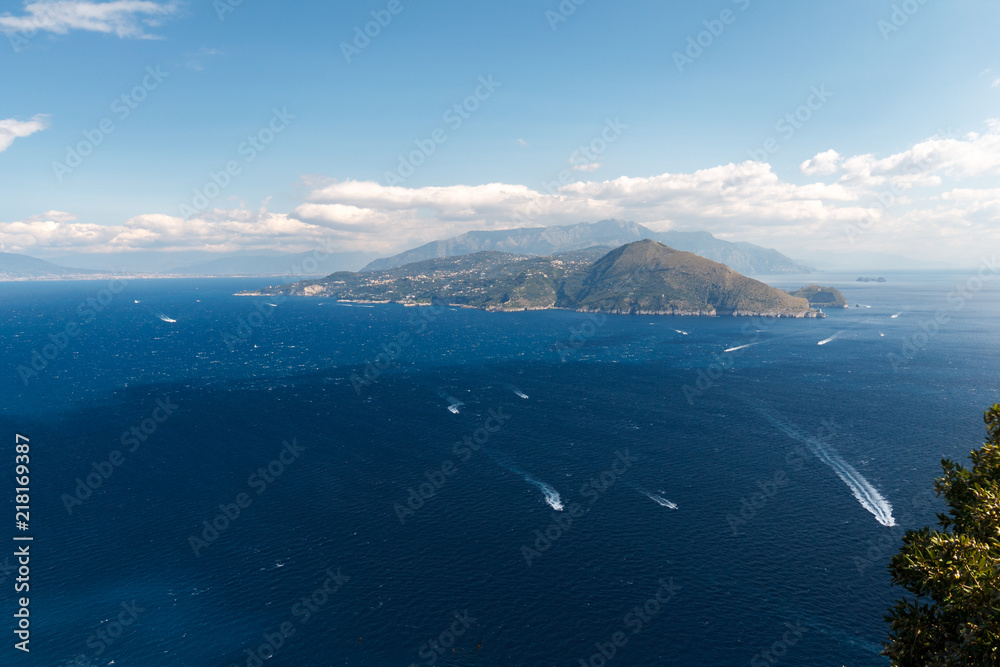 Beautiful aerial view of Capri island, with boat trails on the water Beautiful aerial view of Capri island, with boat trails on the water