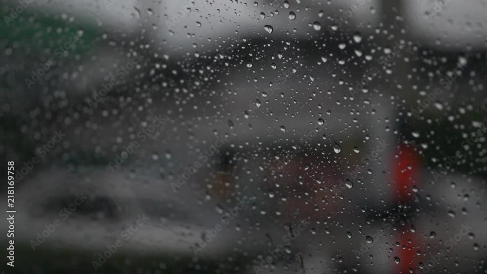 slow motion, rain drops on window car with driving on traffic road slow motion, rain drops on window car with driving on traffic road