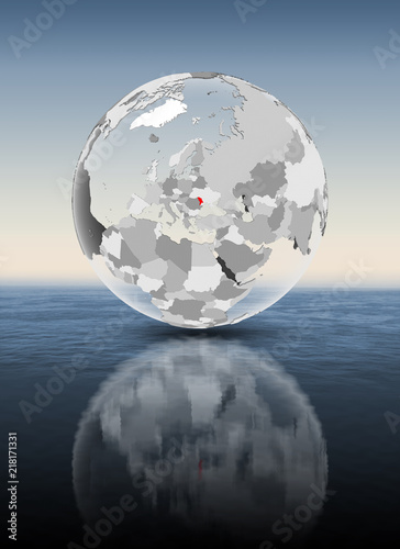 Moldova on translucent globe above water