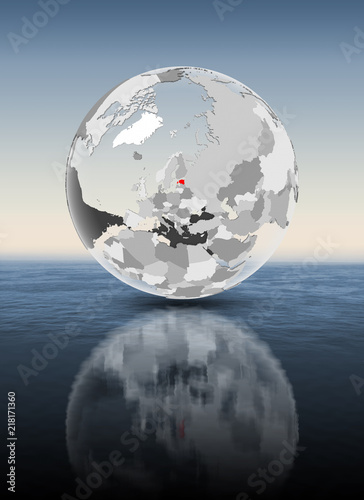 Fototapeta Naklejka Na Ścianę i Meble -  Estonia on translucent globe above water