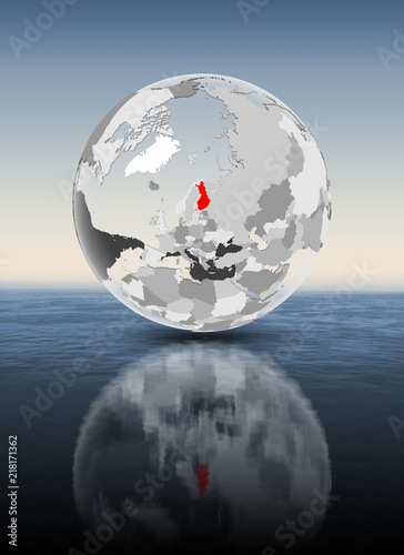 Finland on translucent globe above water