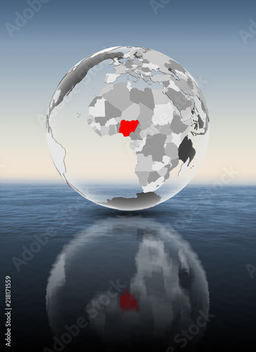 Nigeria on translucent globe above water