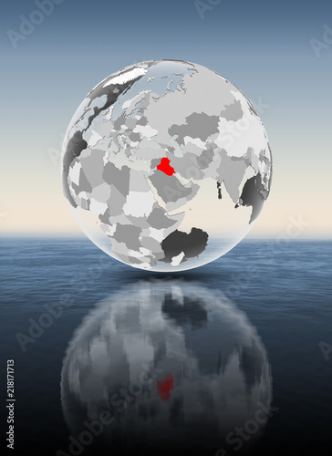 Iraq on translucent globe above water