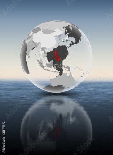 Philippines on translucent globe above water