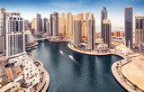 Aerial daytime skyline of Dubai Marina, UAE, with skyscrapers in the distance. Scenic travel background.