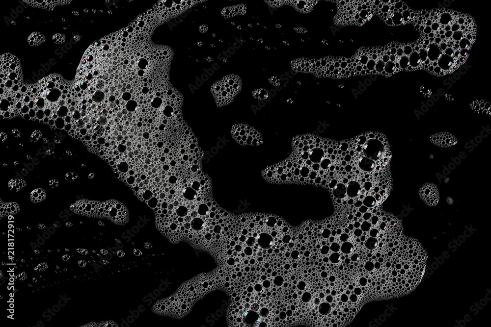 Soap foam with bubbles isolated on black background, with clipping path texture, top view - obrazy, fototapety, plakaty 