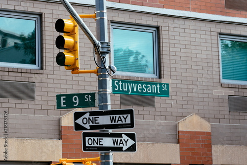 Road sign, one way signs and traffic lights in New York