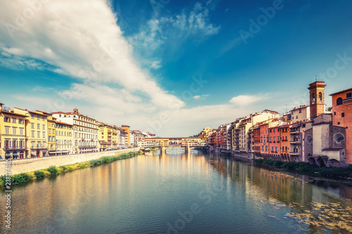 Scenic view on Ponte Vecchio in Florence, Italy, on a summer day with dramatic clouds. Travel background.