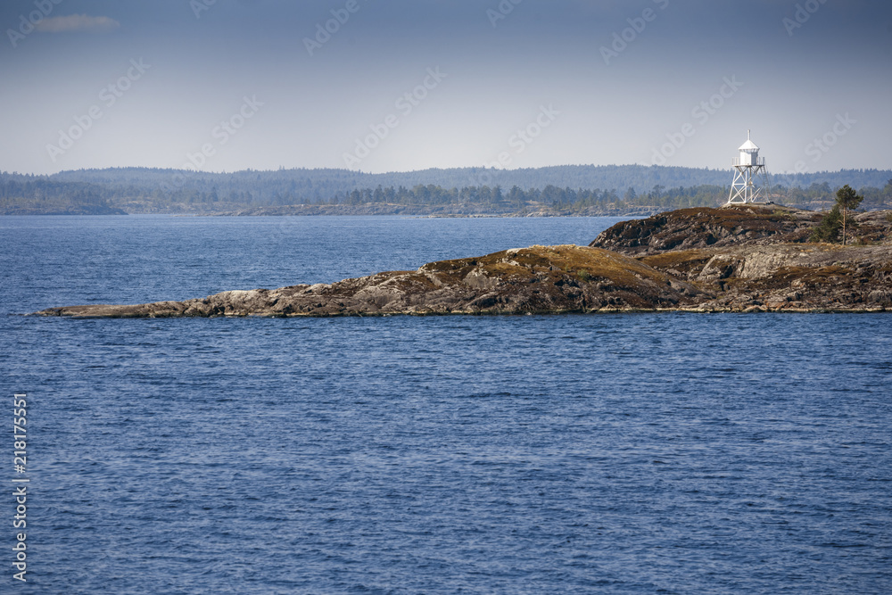 Lighthouse on a rocky island. Beautiful scenery