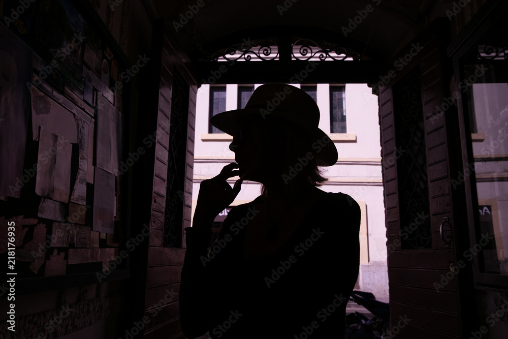 Silhouette of a girl looking at the bulletin board