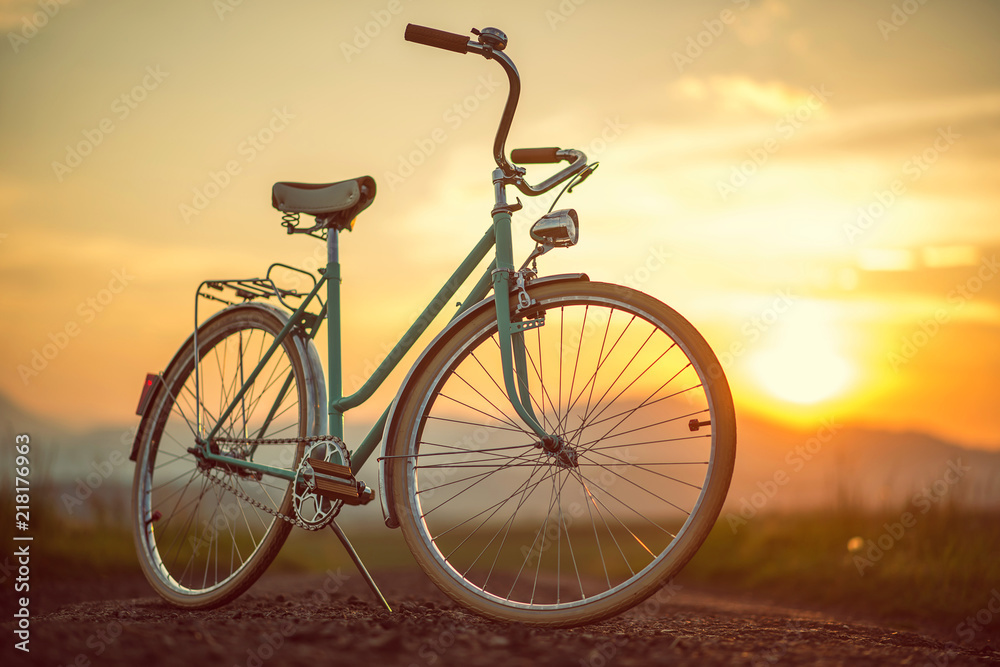 Retro bicycle on the road in sunset, detail photography of bike components Retro bicycle on the road in sunset, detail photography of bike components