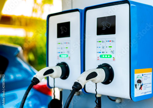 Electric car charging station. Plug for vehicle with electric motor. Coin-operated charging station. Clean energy power. Commercial charging station. Charging point. Infrastructure policy.