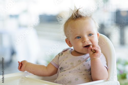 baby eating biscuit