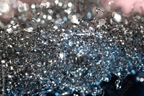 Shiny serpentine tinsel close up with blured background