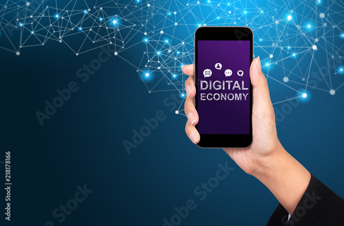 Digital economy concept. digital economy on smartphone screen in businesswoman hand
