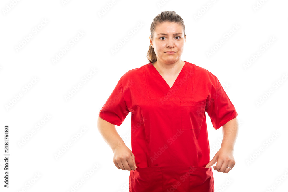 Fototapeta premium Young medical nurse wearing red scrub showing empty pockets gesture.