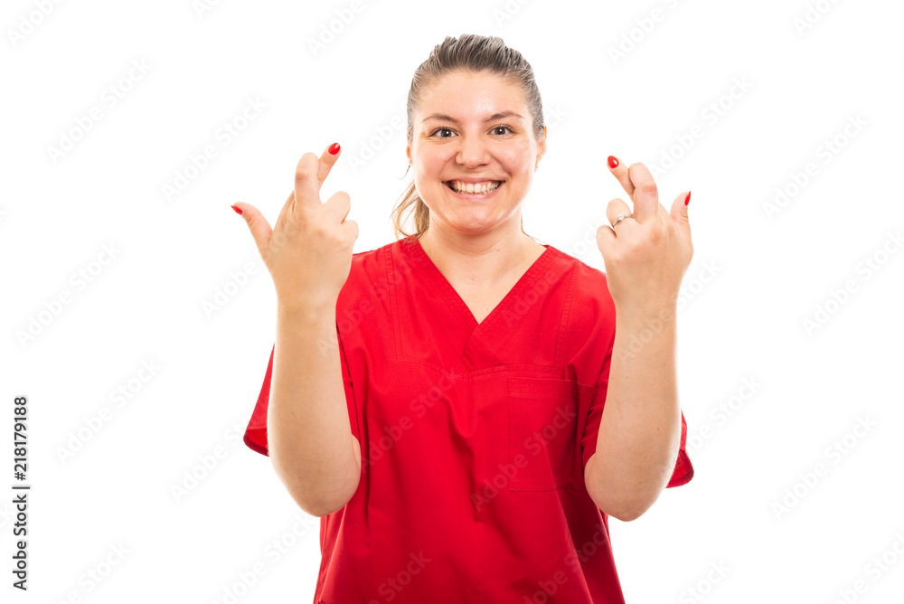 Medical nurse wearing red scrub showing double cross fingers gesture. Medical nurse wearing red scrub showing double cross fingers gesture.