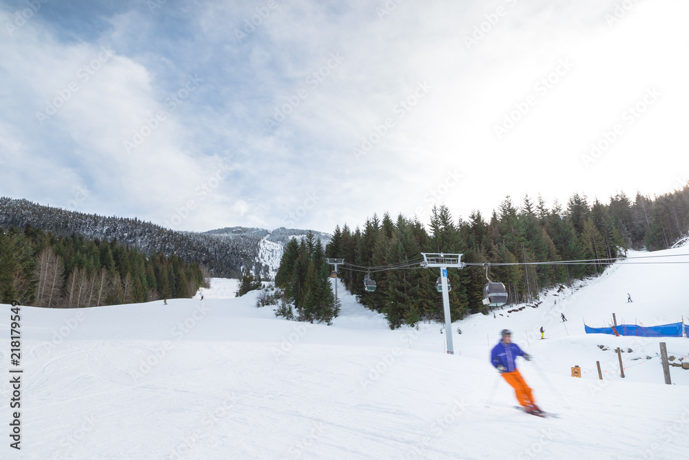 Blurred skiers going downhill on Whistler Mountain. Blurred skiers going downhill on Whistler Mountain.