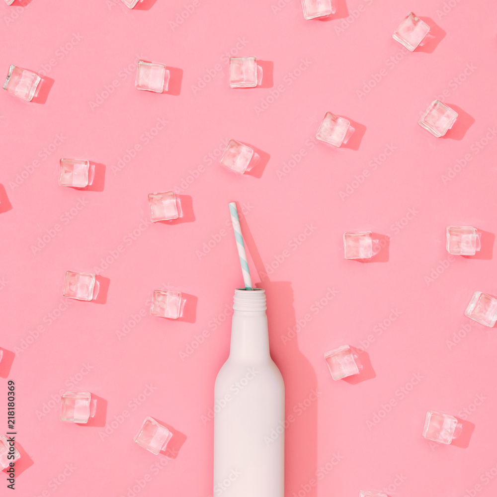 Ice cubes pattern with white painted bottle on pastel pink background. Minimal summer drink concept. Flat lay. Ice cubes pattern with white painted bottle on pastel pink background. Minimal summer drink concept. Flat lay.