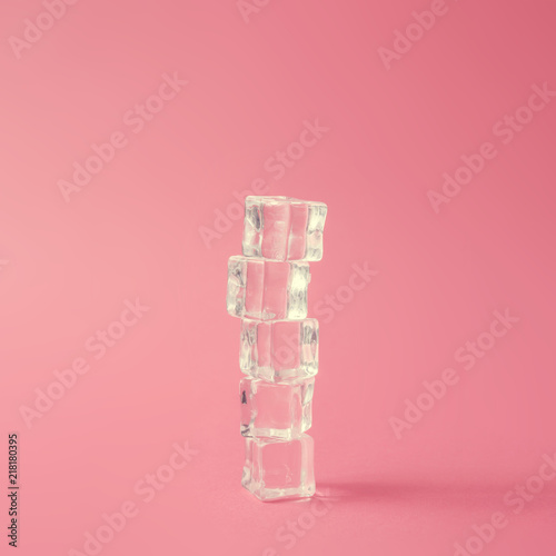 Creative abstract minimal arrangement of ice cubes against pastel pink background. Summer concept.