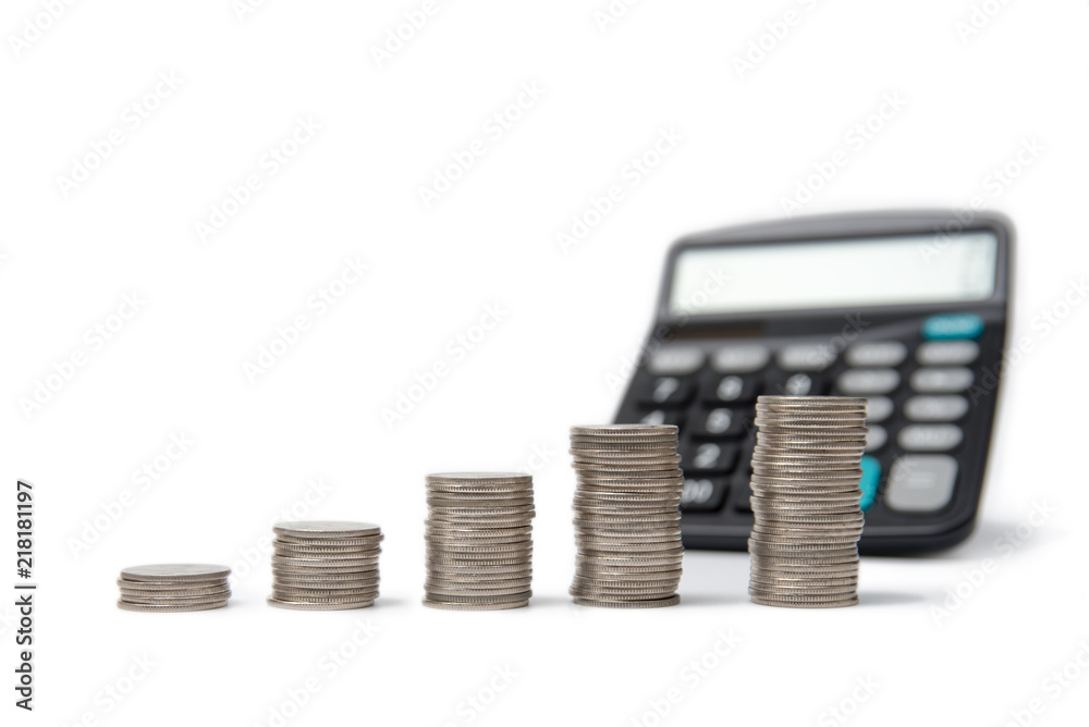 Coin stacks and calculator on a white background. Coin stacks and calculator on a white background.