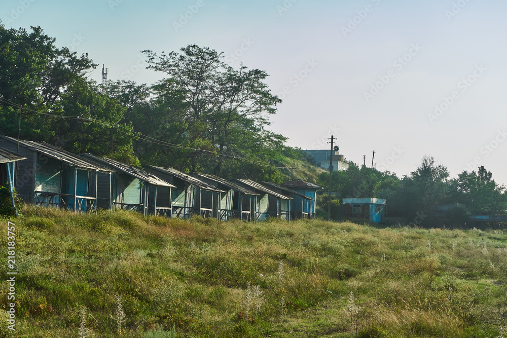 A lot of wooden abandoned houses are intended for leisure tourists near the warm sea. Some houses pose a threat due to collapse