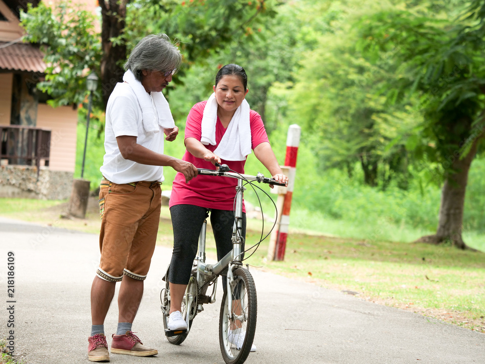 Senior couple lover cyling in Park.Health care concept. Senior couple lover cyling in Park.Health care concept.