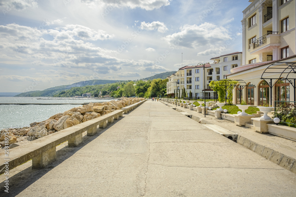 Walkway in the beach with hotel and a bright sky in Balchik, Bulgaria.