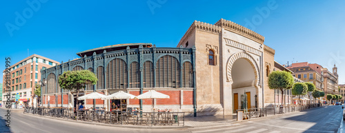 Panorama view of the Arabic marble arch, entrance of the Atarazanas food market in the historic centre of the city of Malaga, Spain photo