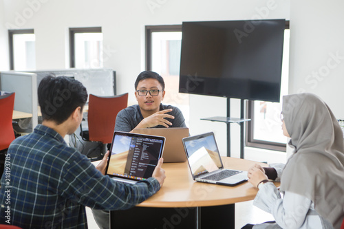 View of business people discussing in meeting room at creative office