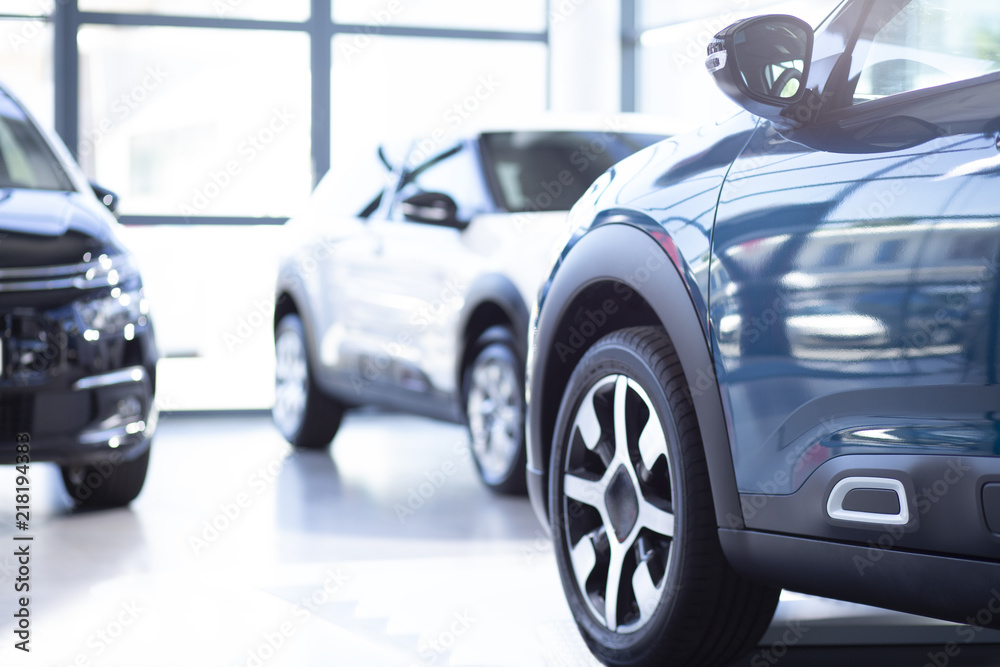Low angle of luxurious car in a exclusive showroom with vehicles Low angle of luxurious car in a exclusive showroom with vehicles
