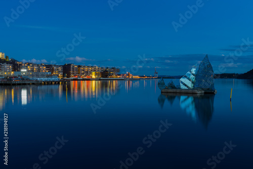 Exterior night view of the city and the glass structure art in the middle of the bay  located in Oslo